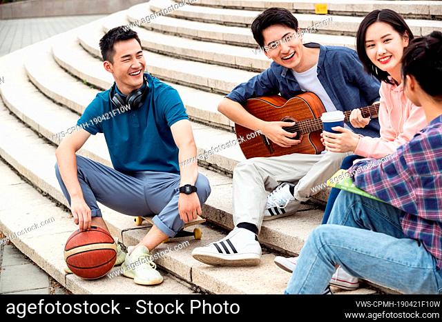 The young college students sat down on the steps, and chatting