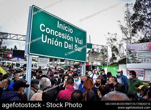 A street sign that reads ""Road concession of Southern Union"" as drivers of public service vehicles hold protest on the Rumichaca International bridge that...