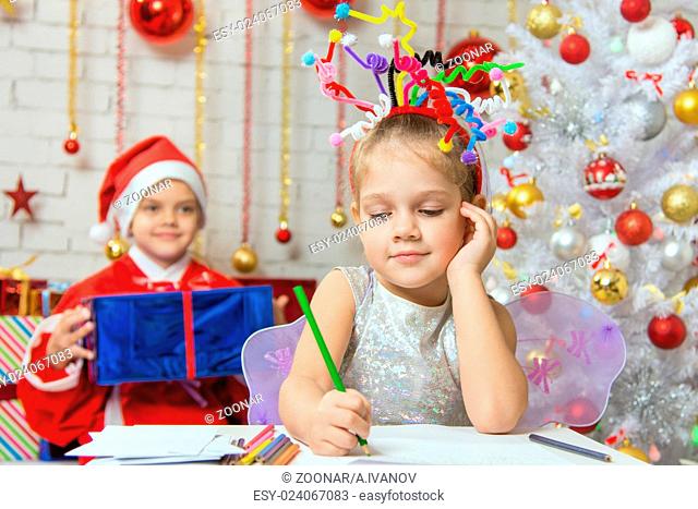 She writes a letter to Santa Claus, who is sitting with a gift behind her