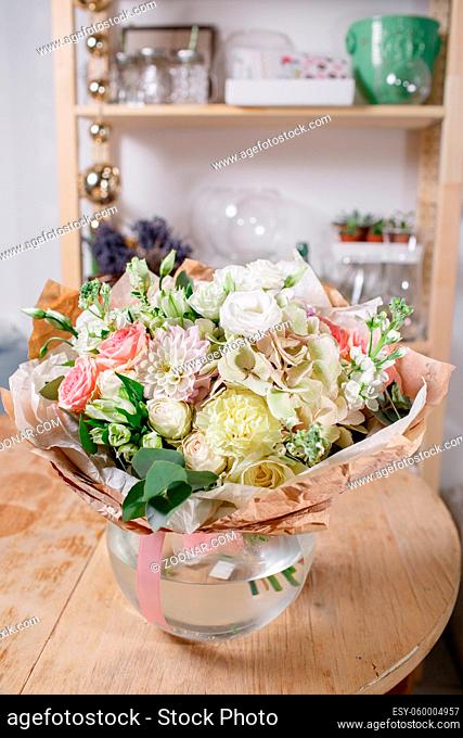 glass vase with Mixed bouquet on wood table. beautiful fresh flowers still life