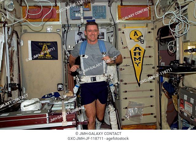 Astronaut William S. McArthur Jr., Expedition 12 commander and NASA science officer, equipped with a bungee harness, exercises on the Treadmill Vibration...