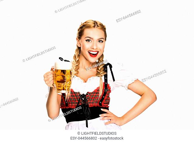 happy waitress in traditional german costume holding beer glass on Oktoberfest, isolated on white