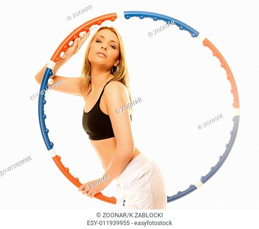 sporty fit girl doing exercise with hula hoop