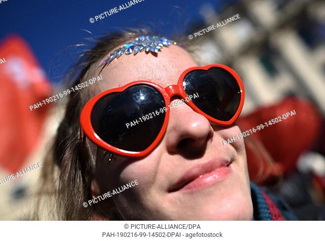 16 February 2019, Bavaria, München: A woman with heart glasses takes part in the demonstration of the Action Alliance against the Munich Security Conference
