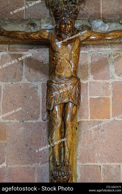 Crucifixion, wood-carved statue behind altar. Interior of Notre Dame Cathedral of Taiohae (Cathédrale Notre-Dame de Taiohae)