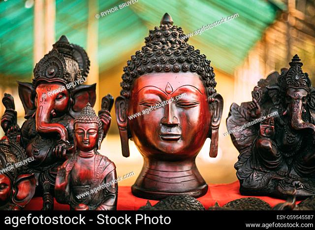 Goa, India. Traditional Store With Statues Different Colors And Sizes. Statues Of Buddha Head And Ganesha On Market. Popular Souvenirs From India