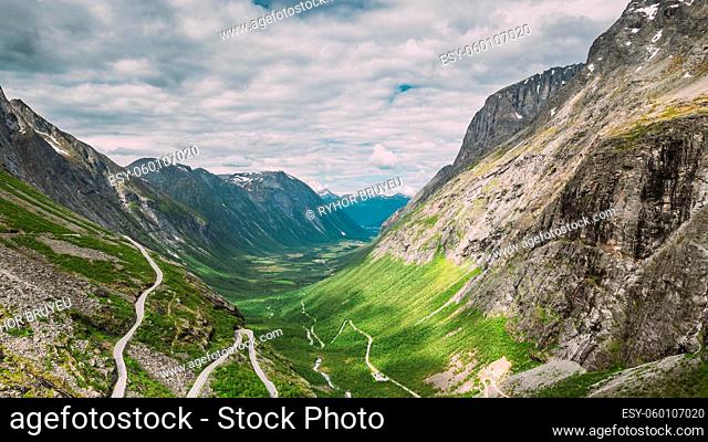 Trollstigen, Andalsnes, Norway. Cars Goes On Serpentine Mountain Road Trollstigen. Famous Norwegian Landmark And Popular Destination