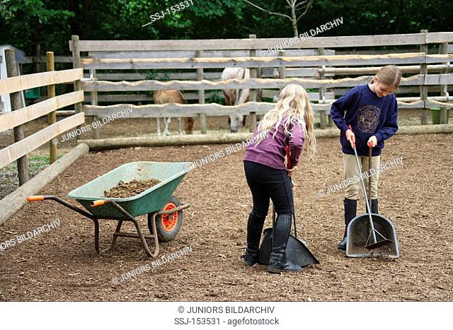children cleaning paddock