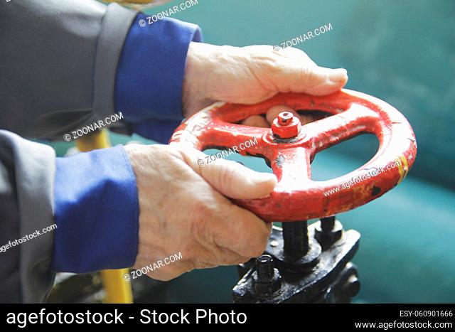 Hand of technician worker open the valve - close up shot