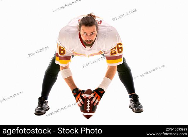 Bearded American football player in whiteuniform, ready to run, isolated on white