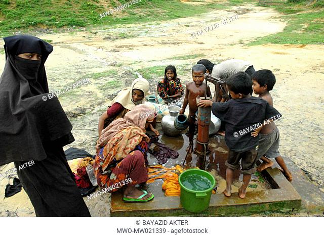 Women and children gathered around the tube-well for daily necessities, at Kutupalong Rohingya Refugee Camp, in Cox’s Bazar Bangladesh October 5, 2009