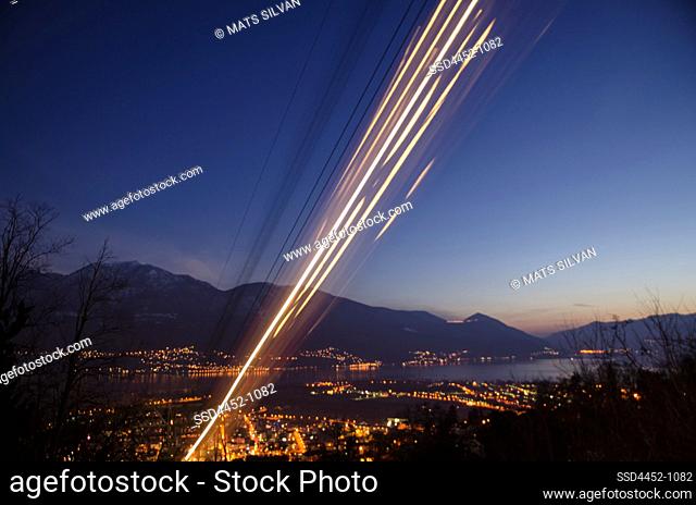 Cableway in Long Exposure over City of Locarno with Alpine Lake Maggiore with Mountain in Ticino, Switzerland