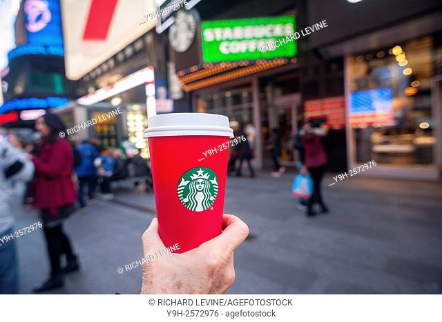 A coffee drinker displays her Starbucks Christmas themed coffee cup in New York on Sunday, November 8, 2015. An Evangelical Christian group is offended by the...