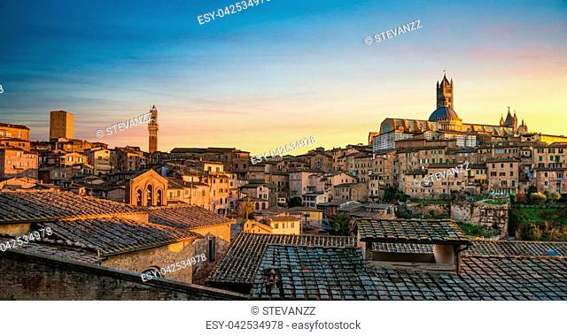 Siena sunset panoramic skyline. Mangia tower and Cathedral Duomo landmark. Tuscany, Italy