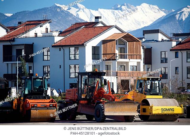 Excavators stand in front of newly build residential houses right beside the Black Sea coast and the Olympic Park in Sochi, Russia, 17 December 2013