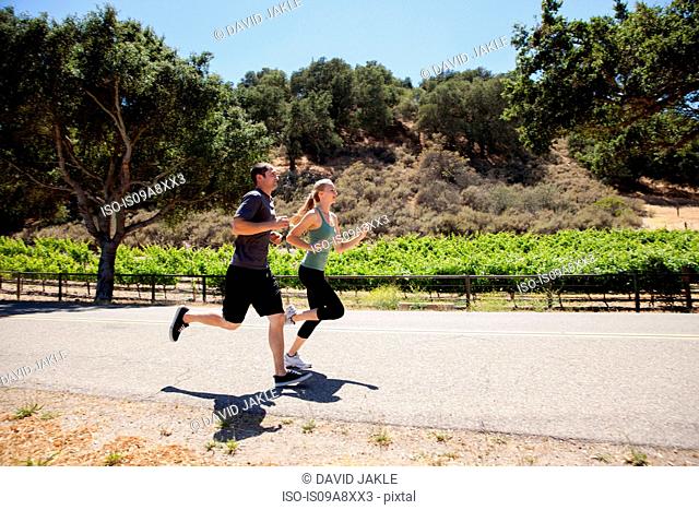 Young couple jogging on road