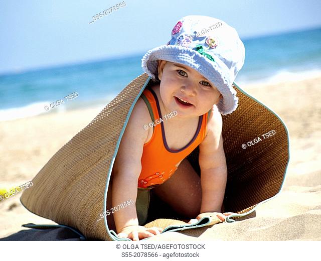 Small girl playing on the beach, Tarragona, Catalonia, Spain