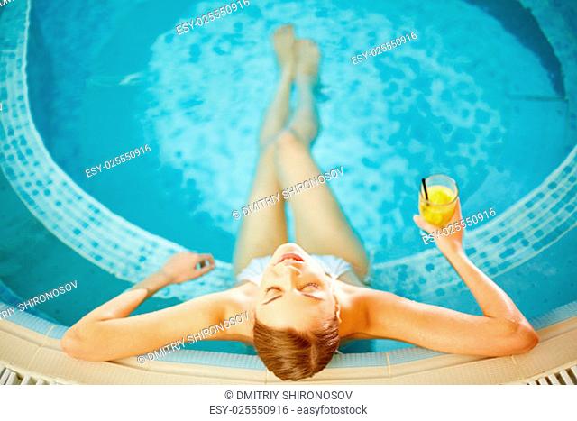 Beautiful girl in bikini relaxing in swimming pool