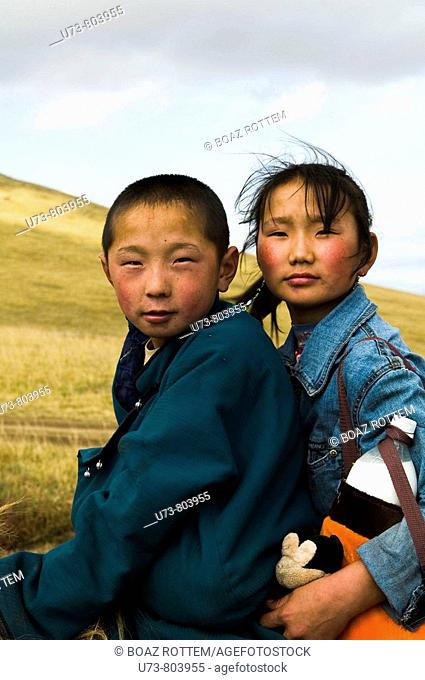 Young Mongolian nomads on their horses