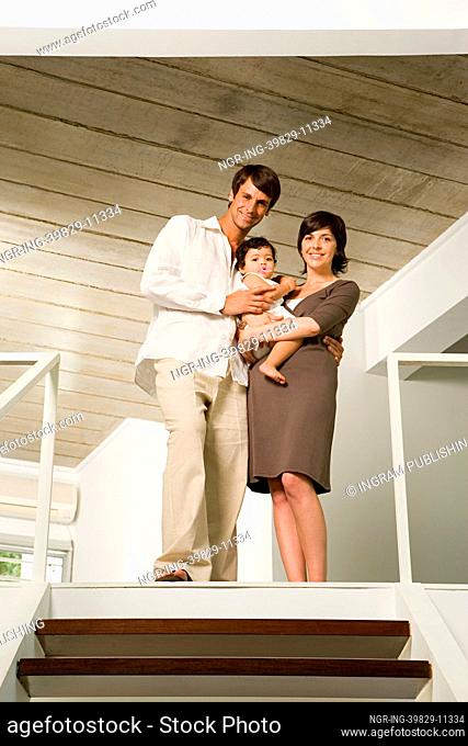 Family standing at the top of stairs