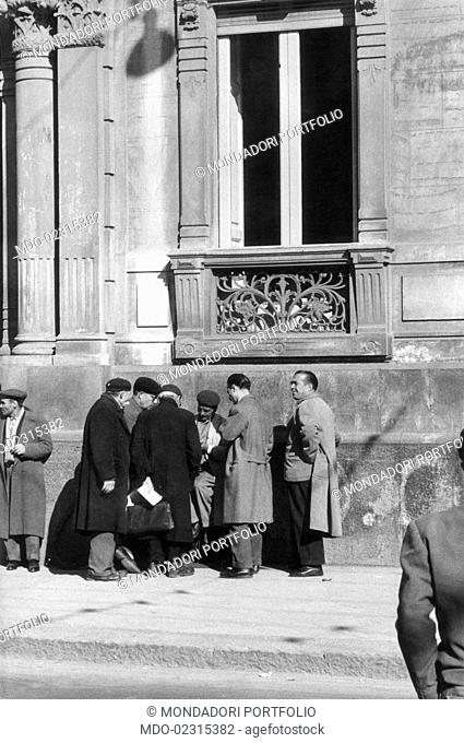A public scribe working in the street. Catania, March 1958