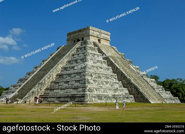 Tourists in front of El Castillo (Temple of Kukulcan), the great Mayan pyramid, in the Chichen Itza Archaeological Zone (UNESCO World Heritage Site) on the...