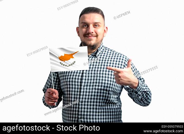 White guy holding a flag of Cyprus and points the finger of the other hand at the flag isolated on a white background