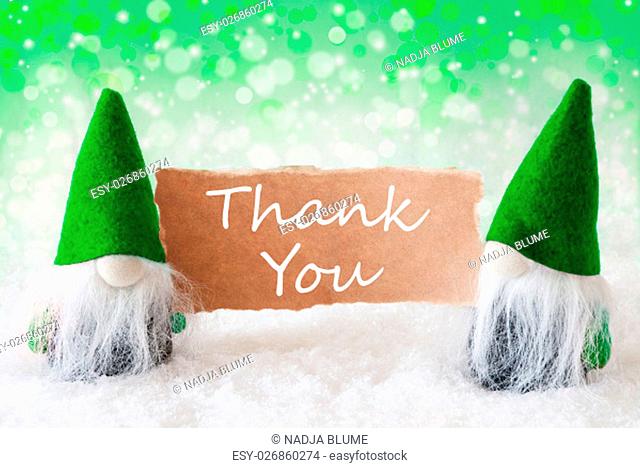 Christmas Greeting Card With Two Green Gnomes. Sparkling Bokeh And Natural Background With Snow. English Text Thank You