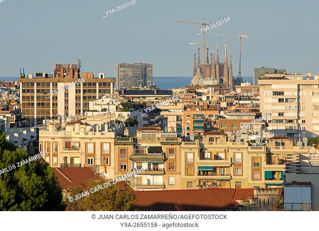 Sagrada Familia church by Antoni Gaudi and partial wiew of Barcelona and Mediterranean Sea, Barcelona, from Esplugues de Llobregat, Catalunya, Spain