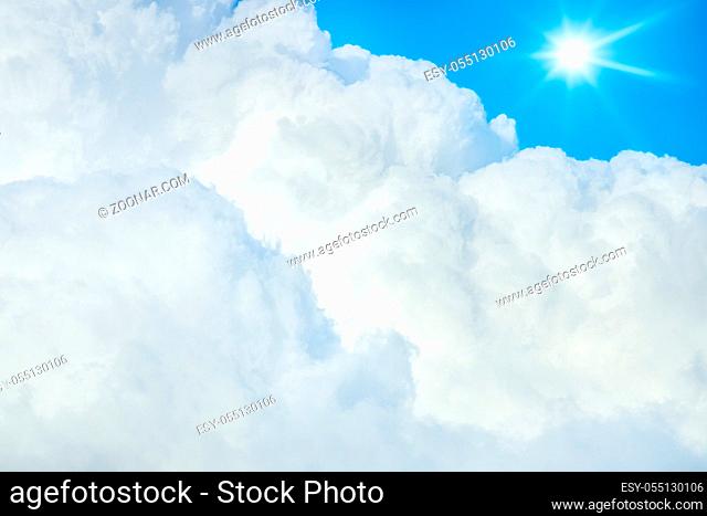 An image of a typical blue sky with sun and clouds background