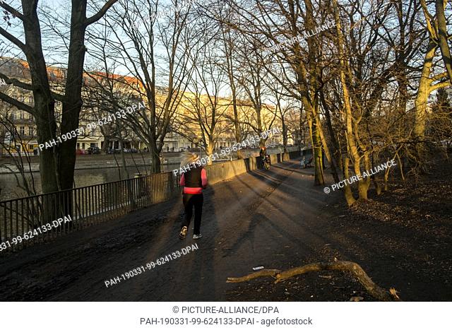 14 February 2019, Berlin: A young woman walks along the banks of the Planufer next to the Landwehr Canal. Photo: Stefan Jaitner/dpa