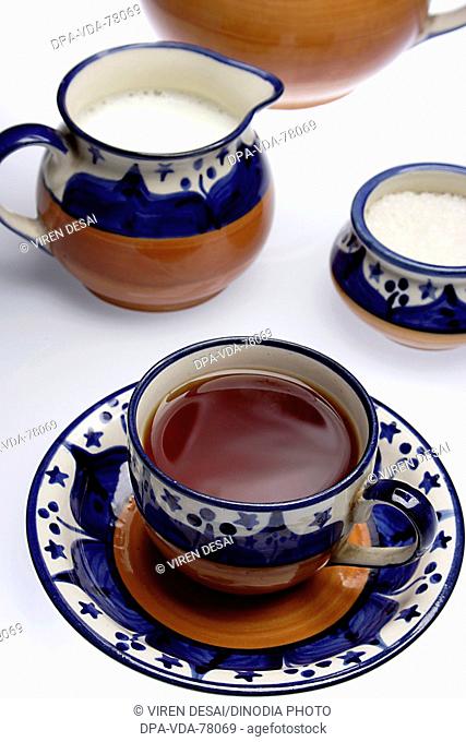 Refreshing drink black tea with tea set and steam