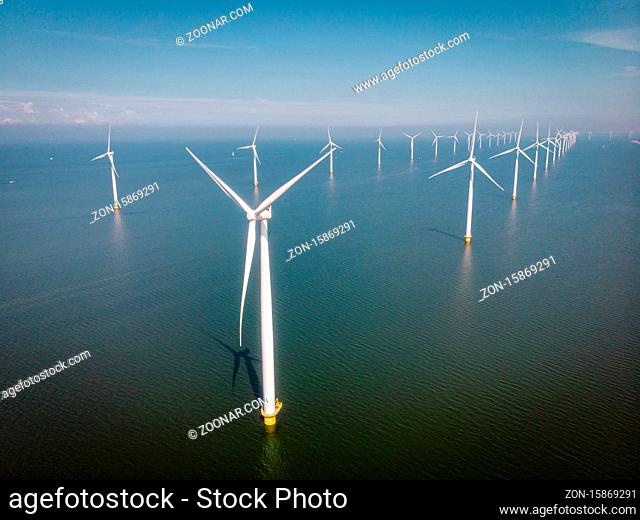 Windmill park westermeerdijk Netherlands, wind mill turbine with blue sky in ocean, green energy, global warming concept