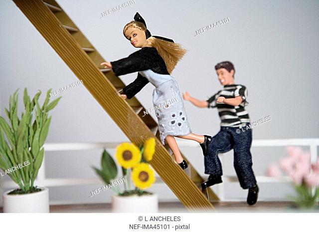 Two dolls running up the stairs