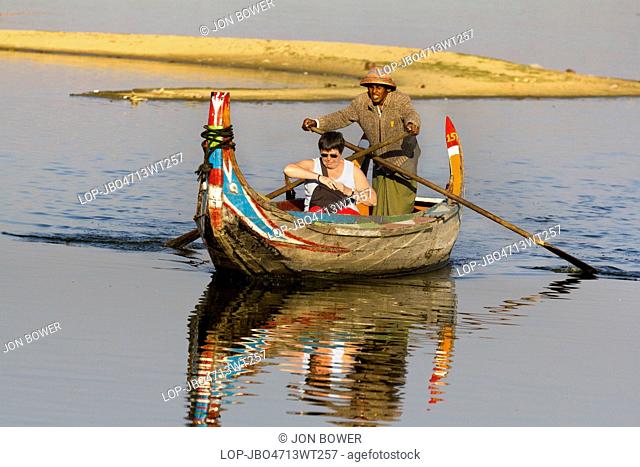 Myanmar, Mandalay, Lake Taungthaman. A tourist boat and passenger on Taungthaman Lake in Myanmar