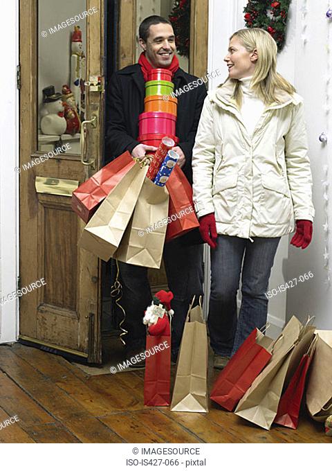 Couple returning home from christmas shopping