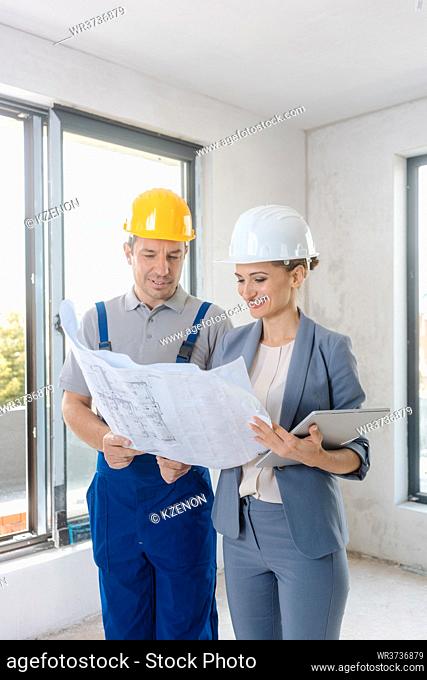 Project owner and construction worker during acceptance checking quality of work
