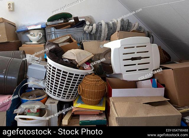 Pile of junk in a house, hoarder room pile of household equipment needs clearing out storage