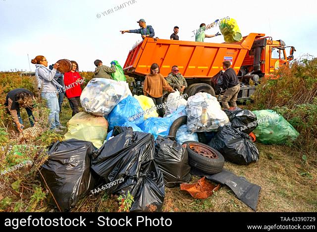 RUSSIA, VLADIVOSTOK - OCTOBER 15, 2023: Volunteers take part in a clean-up event to collect marine debris by a lighthouse on the Basargin Cape in the Eastern...