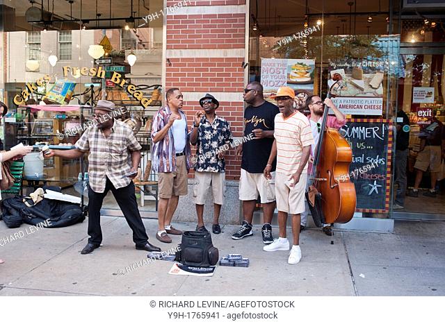 Street musicians sing doo-wop songs on Bleecker Street in Greenwich Village in New York as they entertain the passing tourists and annoy the heck out of the...