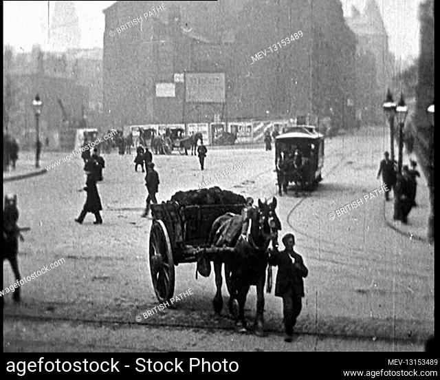 Street Scenes in the United Kingdom. People Are Crossing A Busy Square as a Horse Drawn Tram Pulls Round and A Horse Drawn Cart Passes the Camera - United...