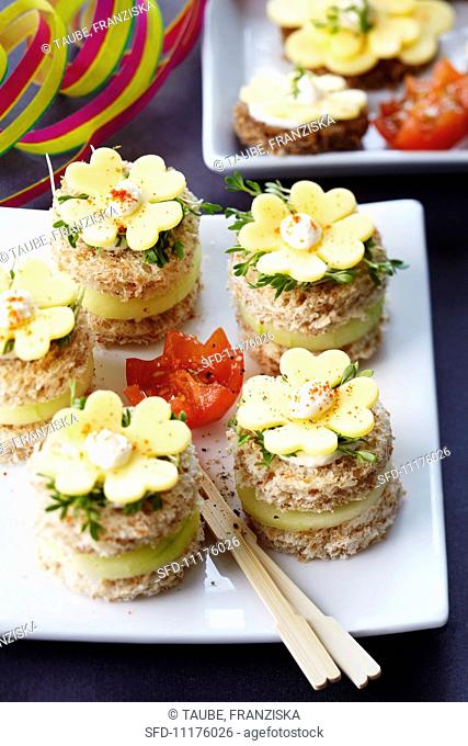 Canapes for New Year's Eve decorated with clover leaf-shaped cheese