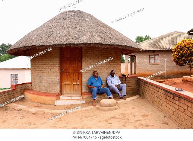 Moshakge Molokwane (L) and Newyear Mabokela (R), members of the royal family of the Lobedu people, sit in front of a traditional round hut in the village of...