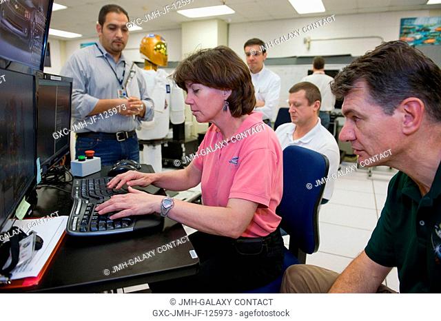 European Space Agency (ESA) astronaut Paolo Nespoli (right foreground) and NASA astronaut Catherine Coleman, both Expedition 2627 flight engineers; along with...