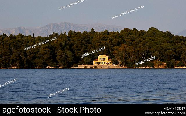 greece, greek islands, ionian islands, lefkada or lefkas, bay of nidri, view of the wooded islet madouri, villa, behind it mainland can be seen