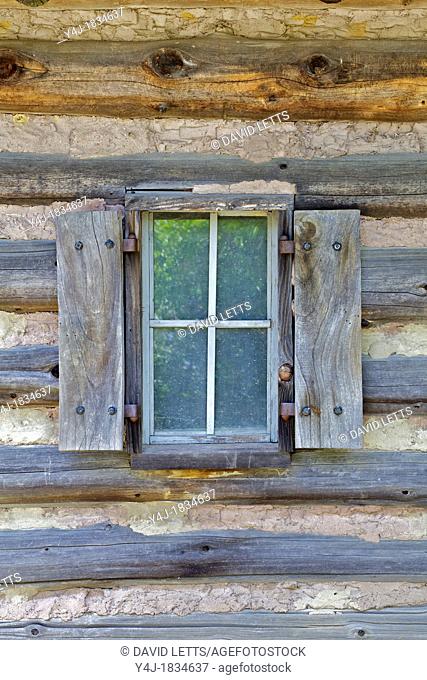 Rustic Window of a Log Cabin with Handmade Wood Shutters