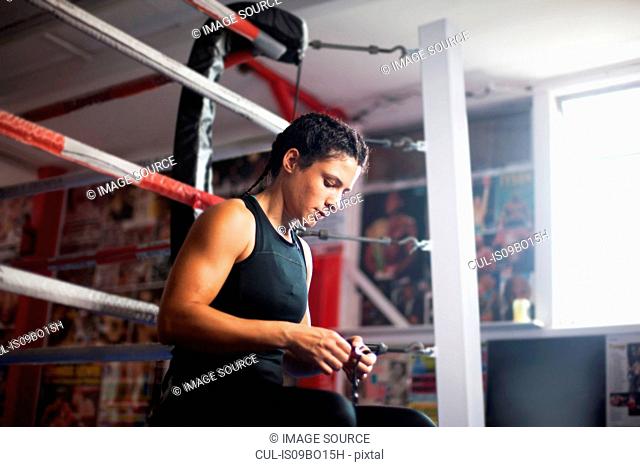Female boxer by boxing ring