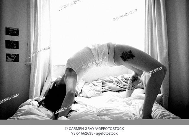 Woman stretching in bed. London