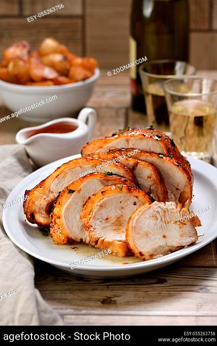 Sliced into slices baked turkey breast  at the dinner table