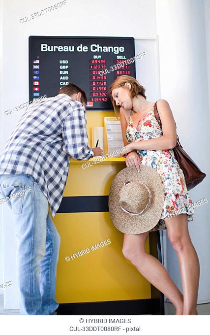 Couple exchanging currency